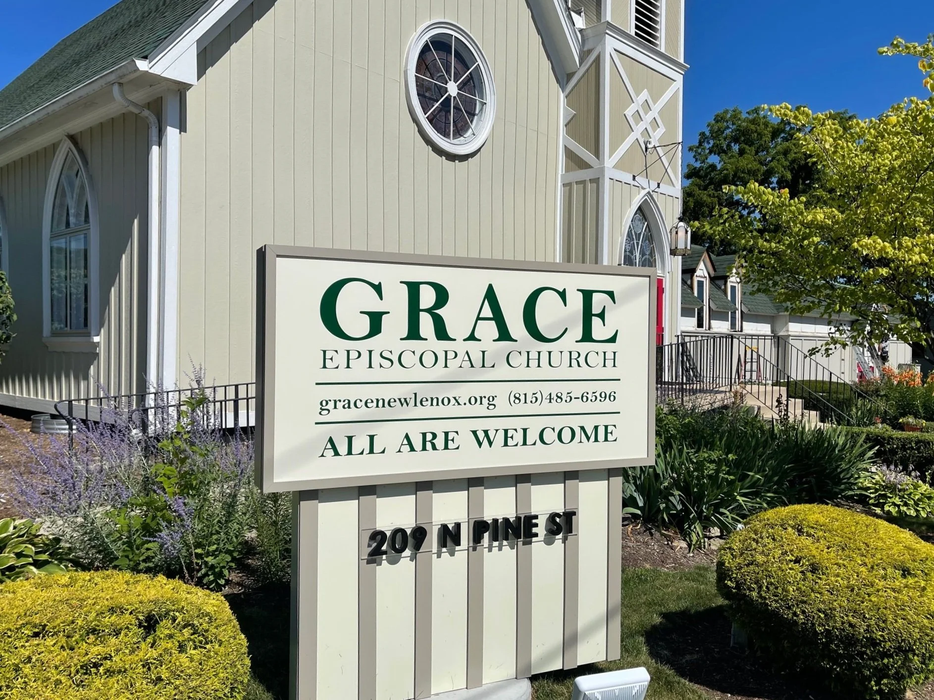 Grace Episcopal Church sign reading All Are Welcome in front of the church at 209 N. Pine Street