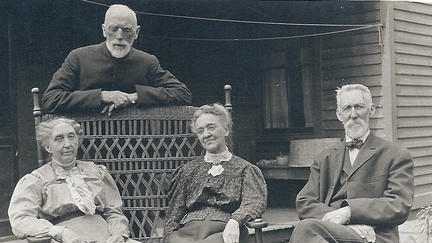 L.W. Applegate (standing) and his wife Rebecca (seated, left), return to New Lenox in 1912 for his second non-consecutive term as rector of Grace. Here they are seated with friends on the porch of the parsonage. This photo was taken in 1913.